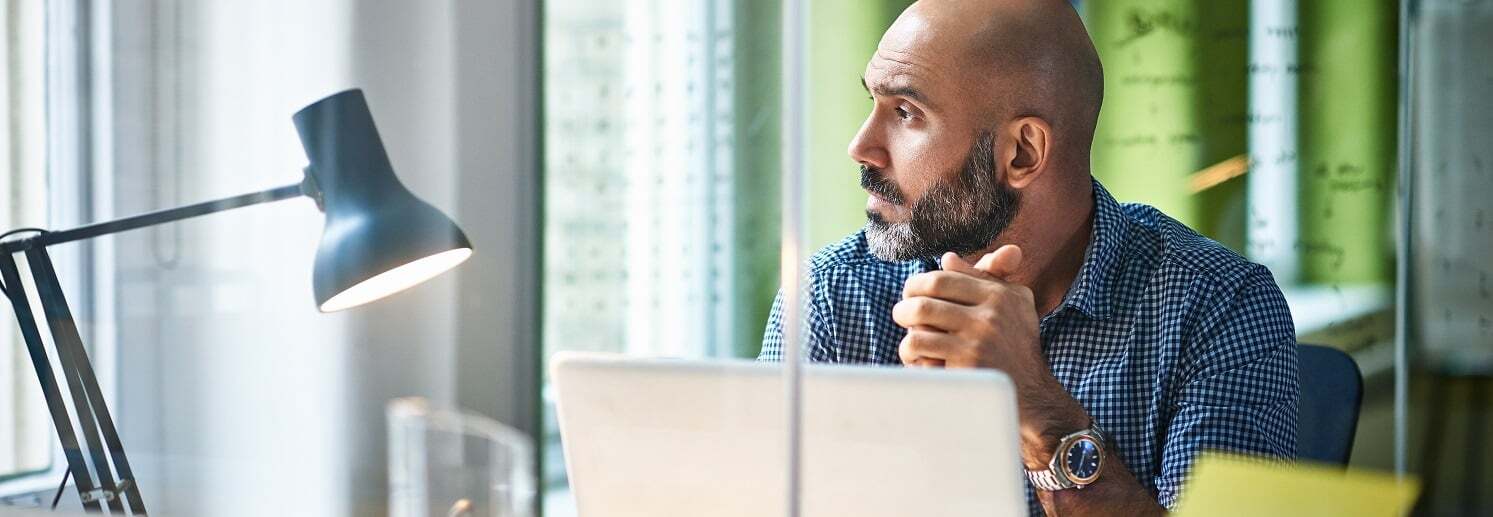 Man sitting at work looking out the window
