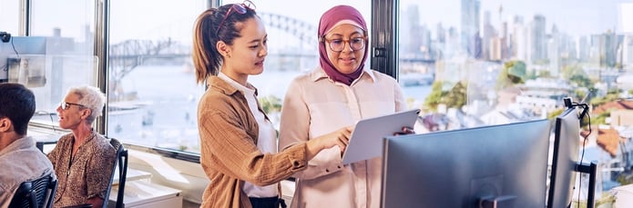 Two women in an office looking at paperwork